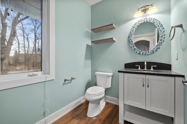 bathroom featuring hardwood / wood-style flooring, vanity, and toilet