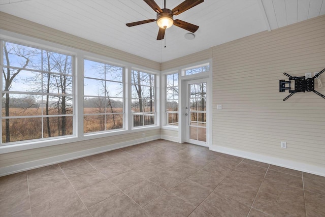 unfurnished sunroom featuring ceiling fan