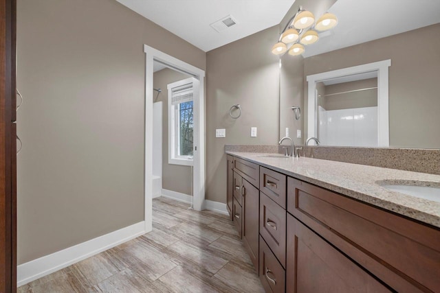 bathroom with vanity and a shower