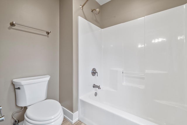 bathroom with shower / washtub combination and toilet