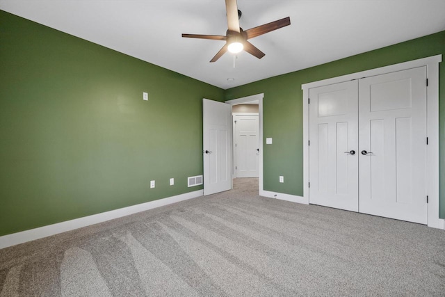 unfurnished bedroom featuring a closet, ceiling fan, and carpet flooring