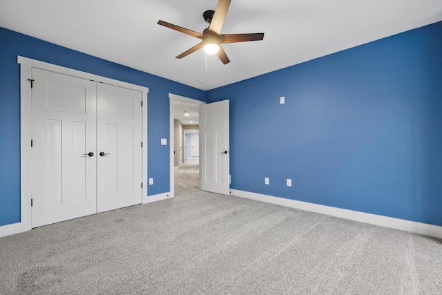 unfurnished bedroom with light carpet, a closet, and ceiling fan