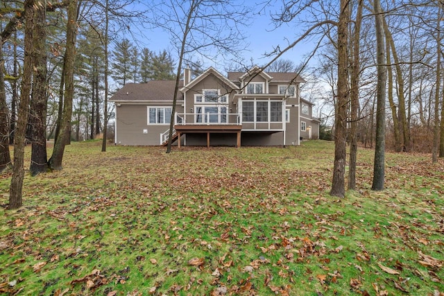 back of house featuring a wooden deck and a sunroom