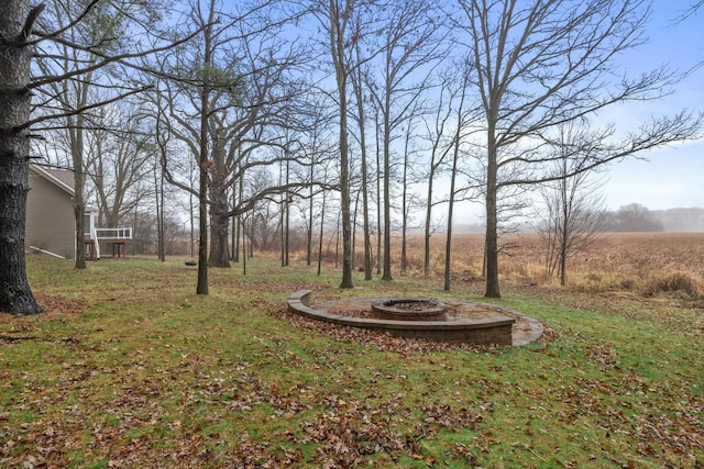 view of yard with a rural view and an outdoor fire pit