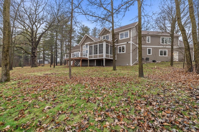 back of house featuring a wooden deck and a sunroom