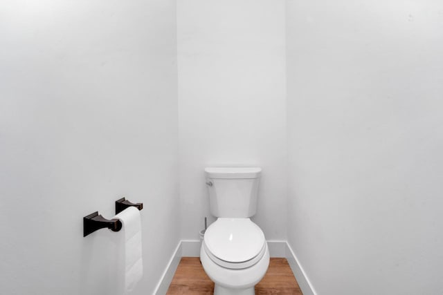 bathroom featuring wood-type flooring and toilet