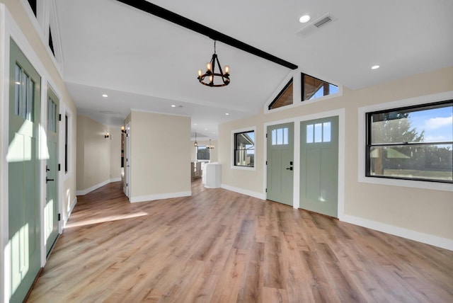 foyer featuring an inviting chandelier, beam ceiling, high vaulted ceiling, and light wood-type flooring