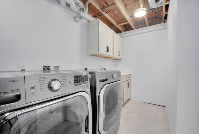 laundry room with washer and clothes dryer and cabinets