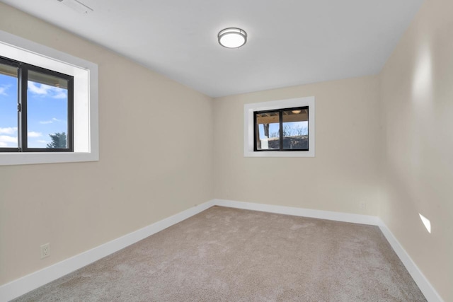 spare room with light colored carpet