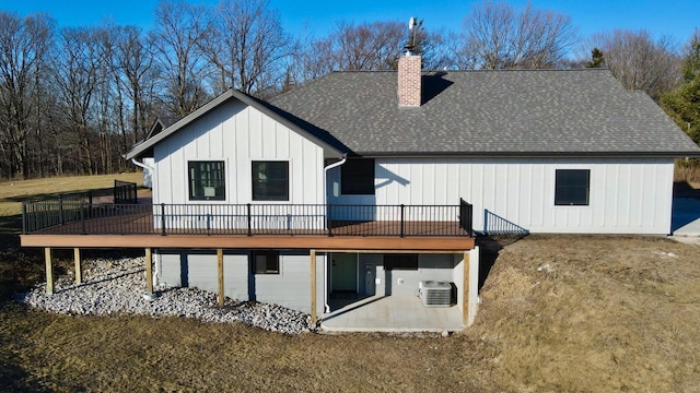 back of house featuring a wooden deck, a lawn, and ac unit