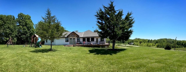 exterior space featuring a wooden deck and a playground