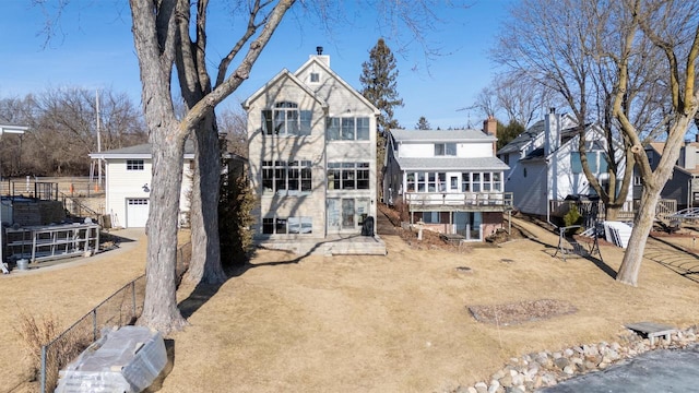 rear view of property with a garage