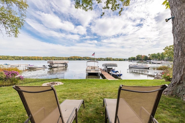 view of dock featuring a yard and a water view