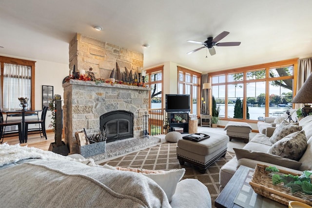 living room featuring a wealth of natural light, a fireplace, ceiling fan, and hardwood / wood-style flooring