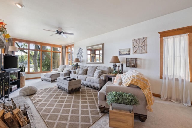 carpeted living room with ceiling fan