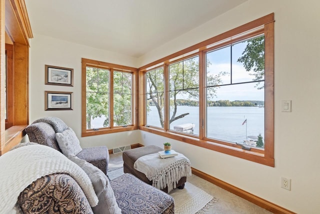 interior space featuring a water view and light carpet