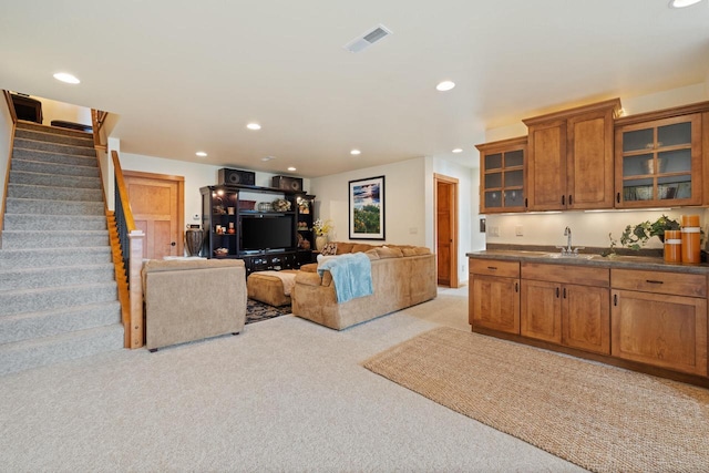 living room with light colored carpet and sink