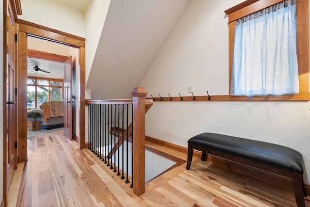 staircase featuring hardwood / wood-style flooring and vaulted ceiling