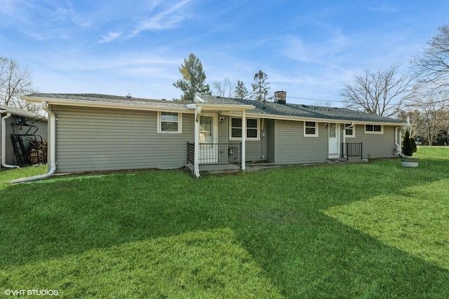 rear view of property with a lawn