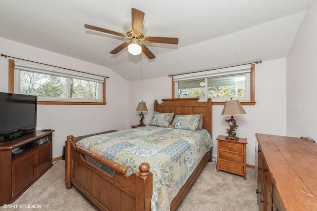 carpeted bedroom featuring vaulted ceiling and ceiling fan