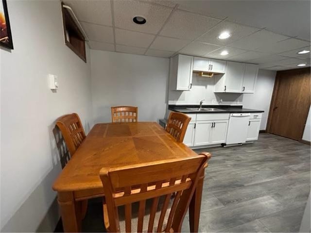 dining area featuring a paneled ceiling, recessed lighting, and wood finished floors