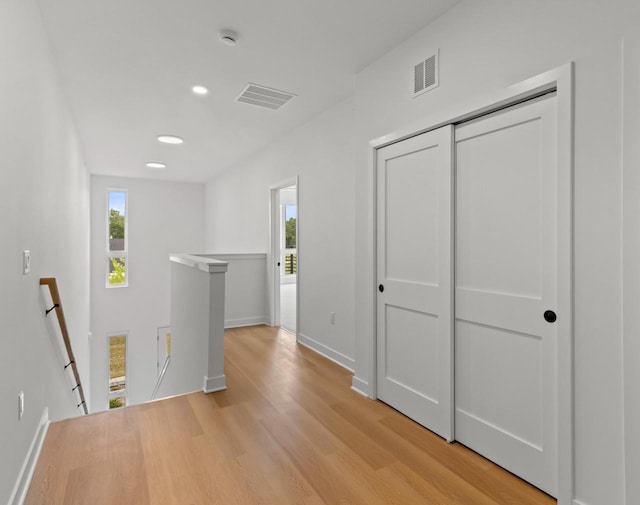 hall featuring plenty of natural light and light wood-type flooring