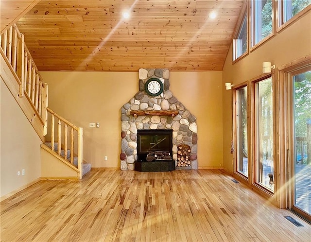 2642 28 1/8 St, Birchwood, WI 54817 - unfurnished living room featuring high vaulted ceiling, a stone fireplace, light hardwood / wood-style floors, and wooden ceiling
