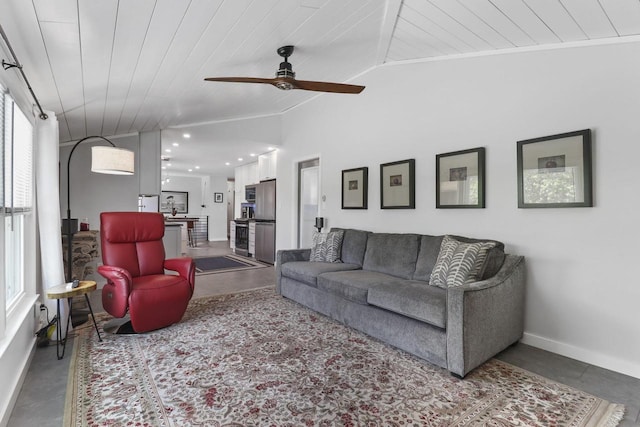 living room with vaulted ceiling, a healthy amount of sunlight, ceiling fan, and wood ceiling