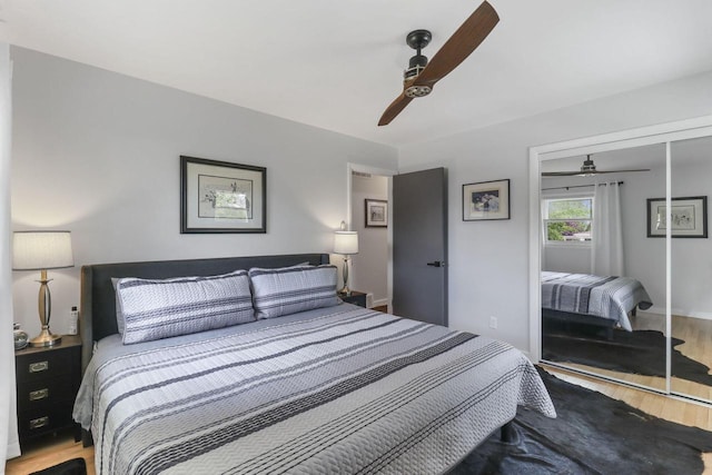 bedroom featuring ceiling fan, light hardwood / wood-style floors, and a closet