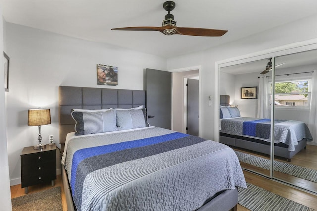 bedroom with hardwood / wood-style floors, ceiling fan, and a closet