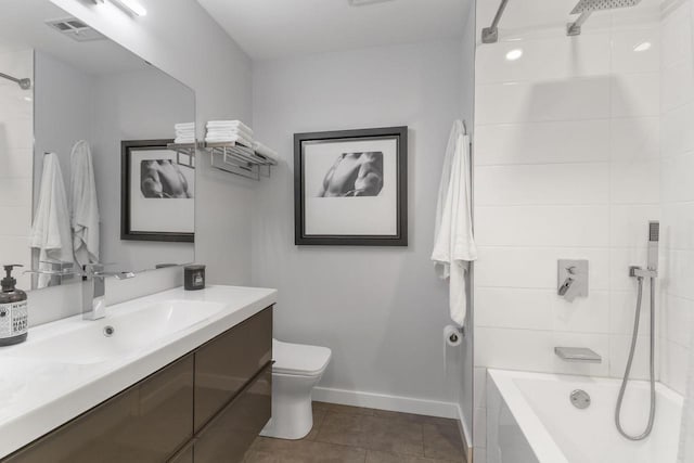 full bathroom featuring tile patterned floors, vanity, toilet, and tiled shower / bath combo