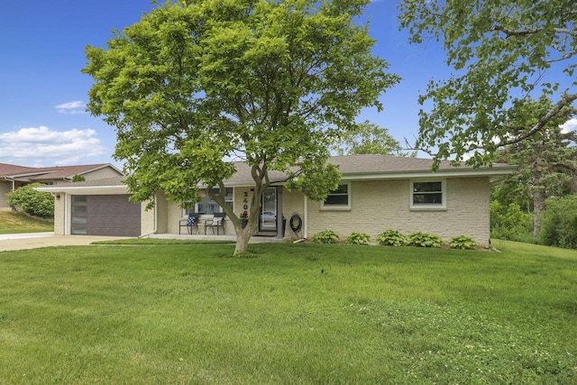 ranch-style house with a garage and a front yard