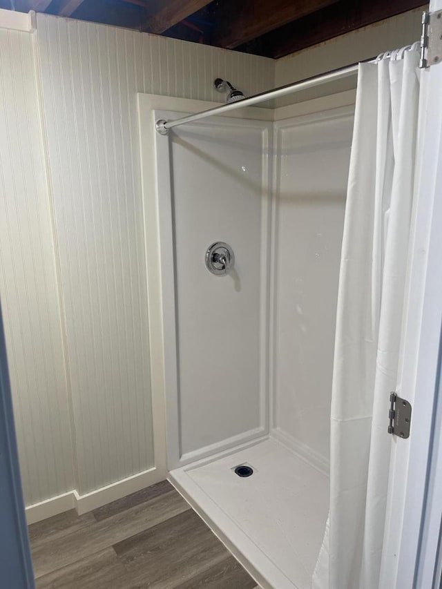 bathroom featuring hardwood / wood-style floors and a shower with curtain