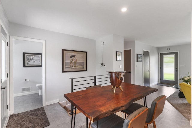 dining space featuring light tile patterned floors