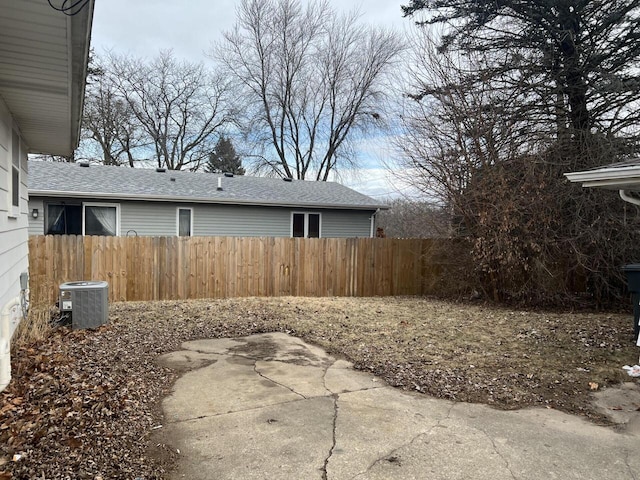 view of yard with central AC and a patio area