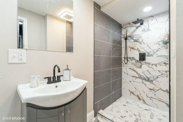 bathroom featuring vanity and a tile shower