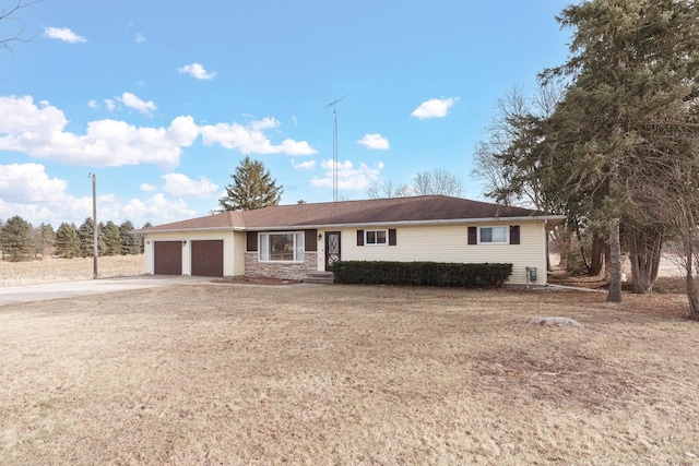 ranch-style home with a garage and a front yard