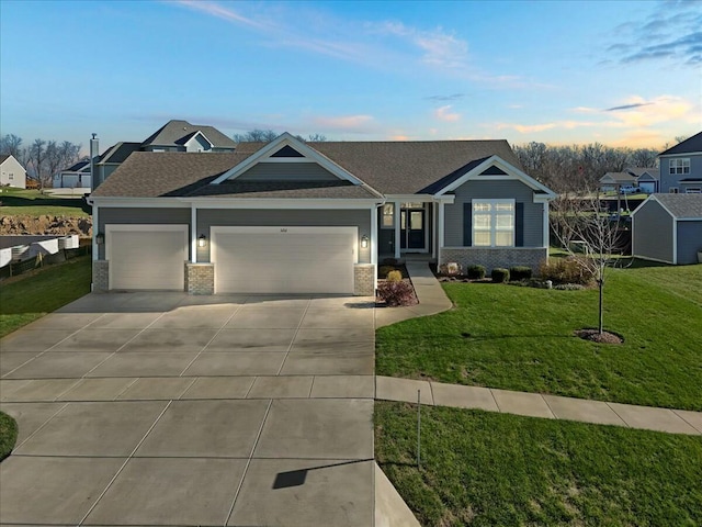 view of front of house with a garage and a lawn