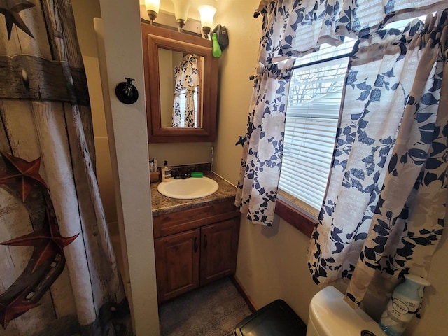 bathroom featuring vanity and toilet