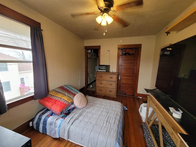 bedroom featuring ceiling fan and dark hardwood / wood-style flooring