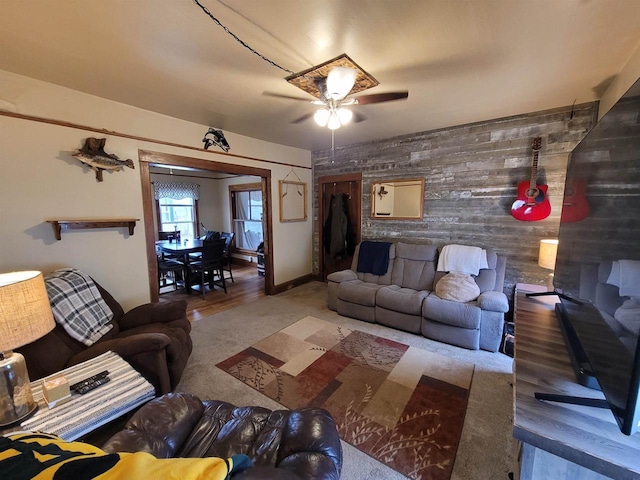 living room featuring wooden walls and ceiling fan