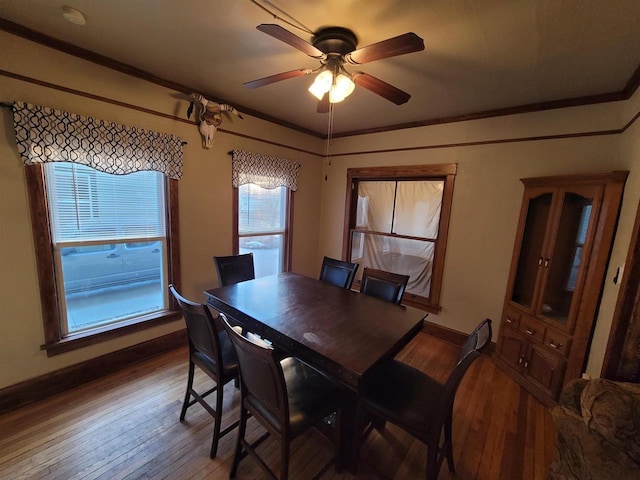 dining space featuring crown molding, ceiling fan, and hardwood / wood-style flooring