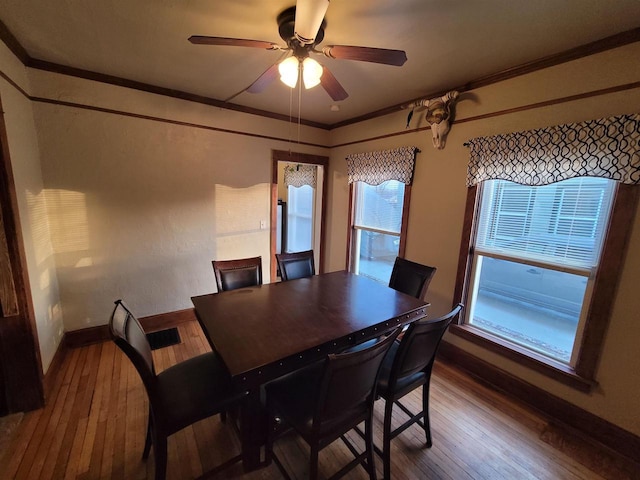 dining area featuring hardwood / wood-style flooring, ornamental molding, and ceiling fan