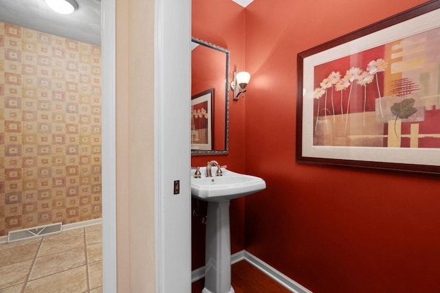 bathroom with tile patterned flooring and sink