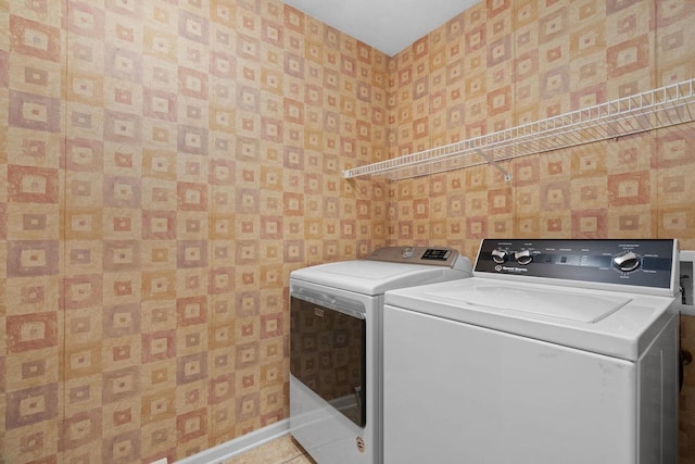 washroom featuring tile patterned floors and washing machine and dryer