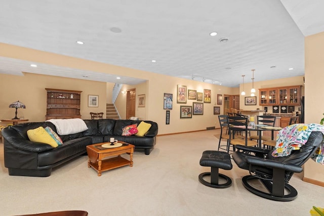 carpeted living room featuring track lighting