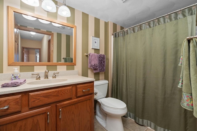 bathroom with tile patterned flooring, vanity, a shower with shower curtain, and toilet