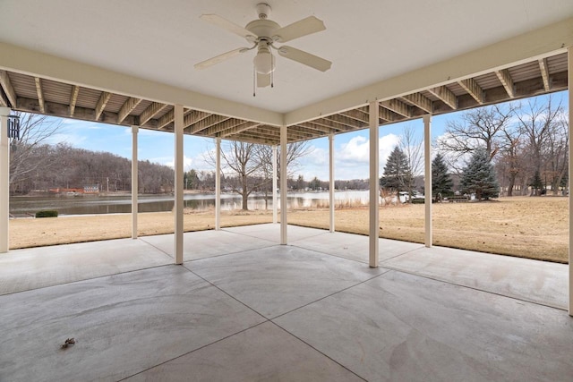 view of patio featuring ceiling fan and a water view