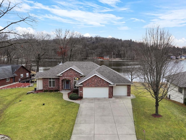 ranch-style home with a garage, a water view, and a front lawn