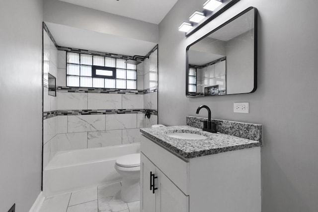 full bathroom with vanity, toilet, and tiled shower / bath